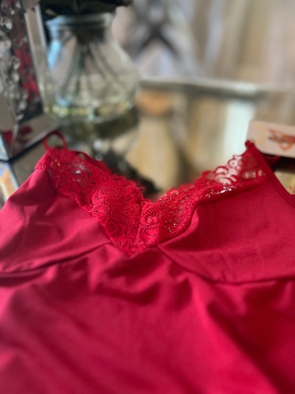 Asymmetrical lace hem detail on red sleep chemise