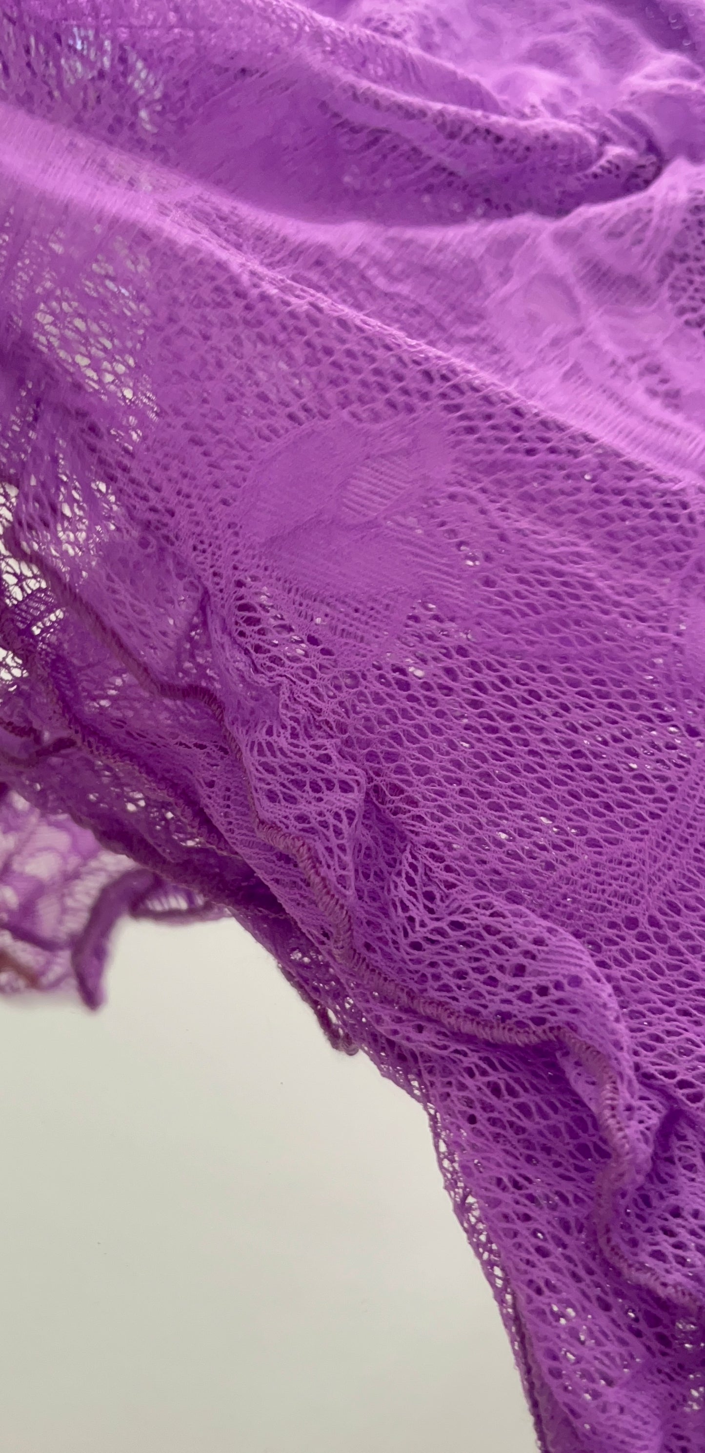Close-up of ruffle trim on Wild Orchid lace romper